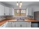 A closer view of the stylish kitchen with butcher block counters and mosaic backsplash at 1322 Thurgood Sw St, Atlanta, GA 30314