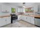 Bright kitchen featuring wood countertops, white cabinets, and stainless steel appliances at 1322 Thurgood Sw St, Atlanta, GA 30314