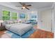 A staged bedroom with a sitting area, hardwood floors, and plenty of natural light at 1322 Thurgood Sw St, Atlanta, GA 30314