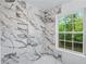 New white marble walk-in shower with window to outside at 1322 Thurgood Sw St, Atlanta, GA 30314