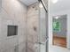 Modern shower design with tiled walls, glass doors and a convenient shower niche at 1322 Thurgood Sw St, Atlanta, GA 30314