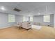 Finished basement area with sitting area, windows for natural light and carpeted floor at 1811 Fountain Hill Ct, Duluth, GA 30097