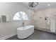 Elegant bathroom with a soaking tub, sleek fixtures, and a separate glass-enclosed shower at 1811 Fountain Hill Ct, Duluth, GA 30097