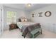 Cozy bedroom with a beautifully decorated bed, a side table with a lamp, and a bench at 1811 Fountain Hill Ct, Duluth, GA 30097