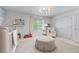 Bright Bedroom featuring a comfortable chair, white crib, and plenty of natural light from the window at 1811 Fountain Hill Ct, Duluth, GA 30097