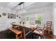 Bright dining room with a rustic wooden table and bench seating at 1811 Fountain Hill Ct, Duluth, GA 30097