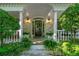 Inviting front porch with white columns, brick accents, and decorative greenery at 1811 Fountain Hill Ct, Duluth, GA 30097