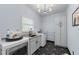 A well-lit laundry room featuring modern washer and dryer appliances and stylish geometric tile floor at 1811 Fountain Hill Ct, Duluth, GA 30097