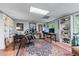 Home office with built-in bookshelves, multiple desks, and bright, natural lighting at 1811 Fountain Hill Ct, Duluth, GA 30097
