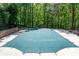 Large in-ground swimming pool covered in green tarp for the off-season at 1811 Fountain Hill Ct, Duluth, GA 30097
