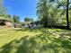 Large backyard with a patio area, ideal for outdoor gatherings, bordered by mature trees providing ample shade at 2682 Pineland Ave, Atlanta, GA 30340