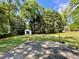 Spacious backyard featuring lush greenery, mature trees, and a shed, perfect for outdoor activities and relaxation at 2682 Pineland Ave, Atlanta, GA 30340