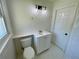 Bathroom with white vanity, tile floors, updated light fixture, and a toilet at 2682 Pineland Ave, Atlanta, GA 30340