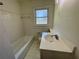 Bright bathroom with white tile, shower/tub combination, and single vanity at 2682 Pineland Ave, Atlanta, GA 30340