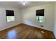 Bedroom featuring hardwood floors, a window with blinds, and neutral wall color at 2682 Pineland Ave, Atlanta, GA 30340