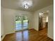 Cozy dining area with hardwood floors, stainless steel appliances, and sliding glass doors to the backyard at 2682 Pineland Ave, Atlanta, GA 30340