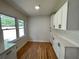 Kitchen area with white cabinets, quartz countertop, wood floors, and a bright window at 2682 Pineland Ave, Atlanta, GA 30340