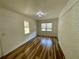 Spacious living room with hardwood floors, brick accent wall, and bright natural light at 2682 Pineland Ave, Atlanta, GA 30340
