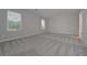Empty bedroom with gray walls and carpet and two windows at 496 Charleston Pl, Villa Rica, GA 30180
