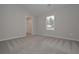 Neutral bedroom showcasing plush carpeting and a walk-in closet at 496 Charleston Pl, Villa Rica, GA 30180