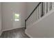 Bright entryway features wood-look flooring and staircase with white railings and black accents at 496 Charleston Pl, Villa Rica, GA 30180