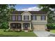 Charming two-story home with a mix of brick, gray siding, and a welcoming covered porch at 496 Charleston Pl, Villa Rica, GA 30180