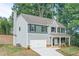 New two-story home with gray siding, black shutters, front porch, and a two-car garage at 496 Charleston Pl, Villa Rica, GA 30180