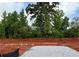 Construction site shows a home's foundation on a wooded lot with trees in the background at 496 Charleston Pl, Villa Rica, GA 30180