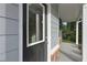 Exterior detail of a home's front door, siding, porch columns, and stonework at 496 Charleston Pl, Villa Rica, GA 30180