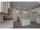Bright kitchen features white cabinets, granite countertops, and stainless steel appliances at 496 Charleston Pl, Villa Rica, GA 30180