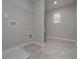 Functional laundry room with tile floors and utility connections at 496 Charleston Pl, Villa Rica, GA 30180