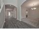 Open-concept living room features sleek flooring, chandelier, and seamless flow to other areas at 496 Charleston Pl, Villa Rica, GA 30180