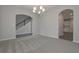 Living room showing carpet flooring, staircase and views to the kitchen at 496 Charleston Pl, Villa Rica, GA 30180