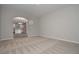 Open-concept living room with neutral carpet leads to kitchen with island, neutral paint at 496 Charleston Pl, Villa Rica, GA 30180