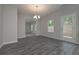 Spacious living area with wood-look flooring, neutral paint, and large sliding glass door at 496 Charleston Pl, Villa Rica, GA 30180