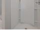 Clean, white shower stall with built-in shelves and modern fixtures for a minimalist design at 496 Charleston Pl, Villa Rica, GA 30180