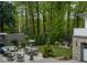 This home's backyard features a patio with dining and seating areas, along with lush landscaping and a privacy fence at 1272 N Highland Ne Ave, Atlanta, GA 30306