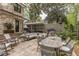 This backyard has a stone patio with dining and lounge seating, an outdoor grill, and manicured landscaping at 1272 N Highland Ne Ave, Atlanta, GA 30306