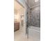 Modern bathroom with decorative tile accent wall, tub, glass enclosure, and marble vanity at 1272 N Highland Ne Ave, Atlanta, GA 30306