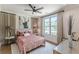 Comfortable bedroom with upholstered headboard, accent pillows, modern ceiling fan and ample natural light at 1272 N Highland Ne Ave, Atlanta, GA 30306