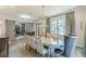 View of a dining room with sliding barn doors, chandelier, hardwood floors, and large windows at 1272 N Highland Ne Ave, Atlanta, GA 30306