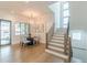 A dining room with a modern chandelier, windows, and staircase to the second floor at 1272 N Highland Ne Ave, Atlanta, GA 30306