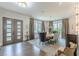 View of a dining room boasting a modern chandelier, many windows, and stylish decor and furniture at 1272 N Highland Ne Ave, Atlanta, GA 30306