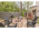 The backyard has a beautiful stone firepit area surrounded by comfortable seating and lush landscaping, perfect for entertaining at 1272 N Highland Ne Ave, Atlanta, GA 30306