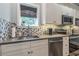 This modern kitchen features white cabinets, stainless steel appliances, and sleek countertops for easy meal preparation at 1272 N Highland Ne Ave, Atlanta, GA 30306