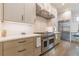 A modern kitchen featuring stainless steel appliances, a range with a hood, and light-colored cabinetry at 1272 N Highland Ne Ave, Atlanta, GA 30306