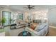 A living room with a fireplace, couches, and a view of the kitchen and staircase at 1272 N Highland Ne Ave, Atlanta, GA 30306
