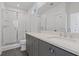 Modern bathroom featuring double vanity, grey cabinets, quartz countertops, and a glass-enclosed shower at 1779 Beckham Ne Pl # 58, Atlanta, GA 30324