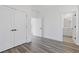 Bedroom with hardwood floors, double closets, and views into an ensuite bathroom at 1779 Beckham Ne Pl # 58, Atlanta, GA 30324