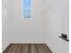 Walk-in closet with wood floors, white trim, a window, and wire shelving at 1779 Beckham Ne Pl # 58, Atlanta, GA 30324